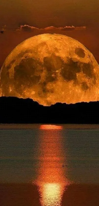 Orange moon reflecting on a serene lake at night.