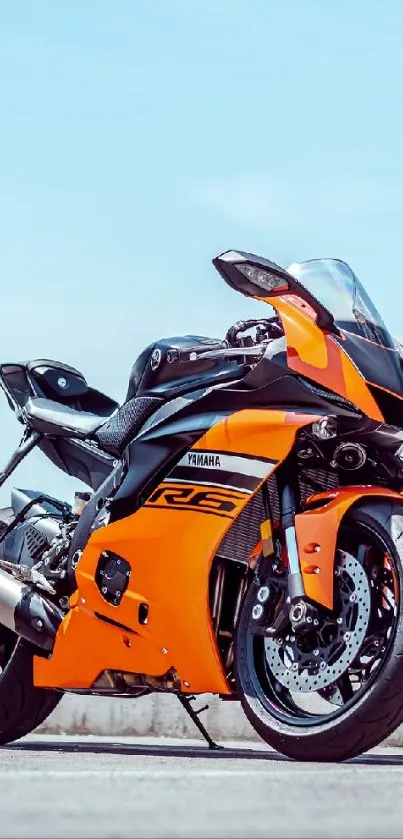 Sporty orange motorcycle parked on road