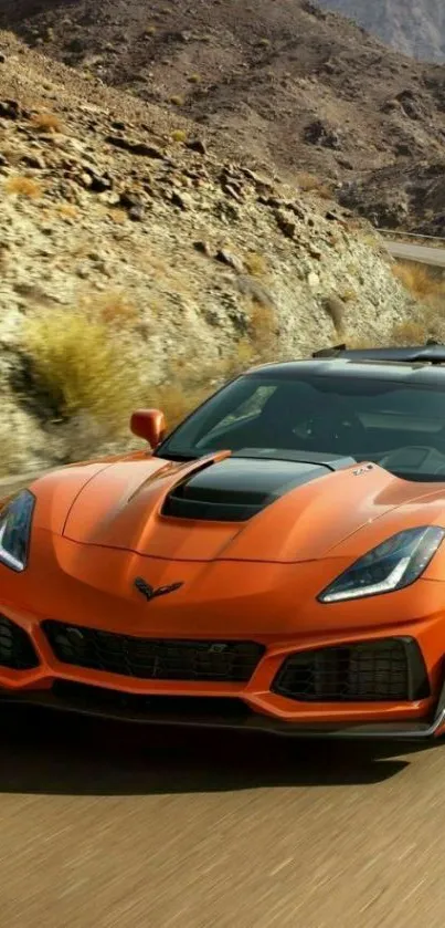 Orange sports car speeding on a desert road.