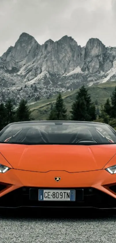 Orange sports car with mountain backdrop on mobile wallpaper.