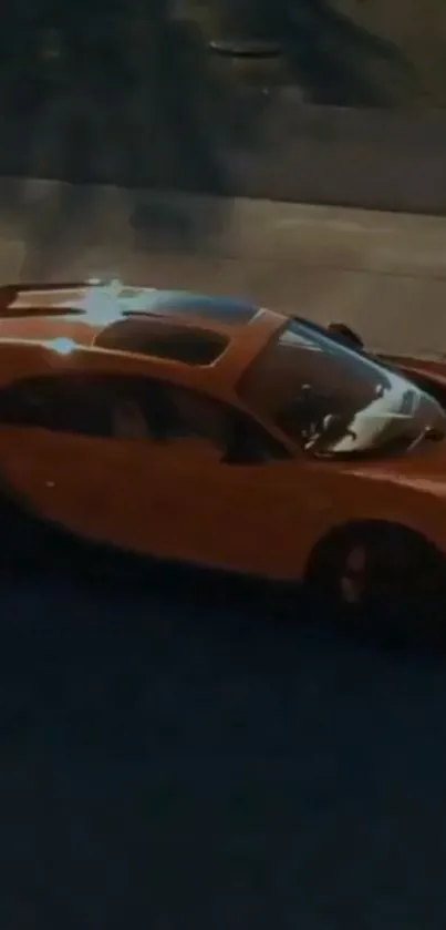 Orange sports car driving at night on city street.