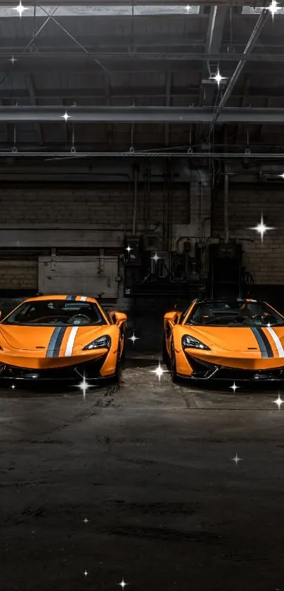 Two bright orange sports cars in an industrial garage setting.