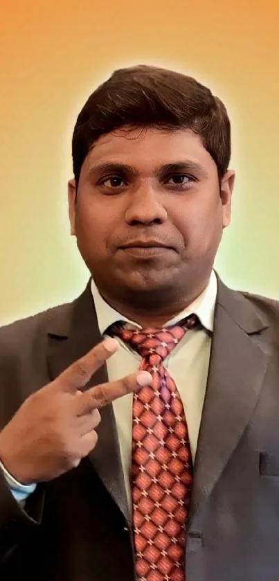 Professional portrait with orange background in a suit and tie.