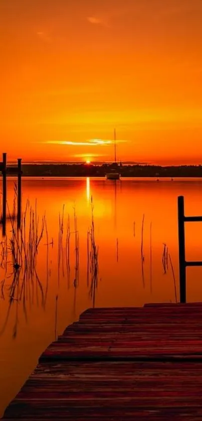 Serene lake with orange sunset and dock silhouette mobile wallpaper.