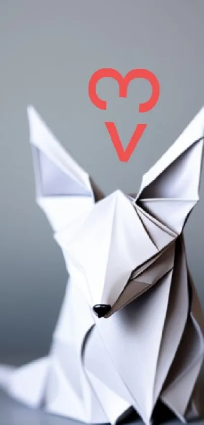 Origami fox with red heart on gray background.