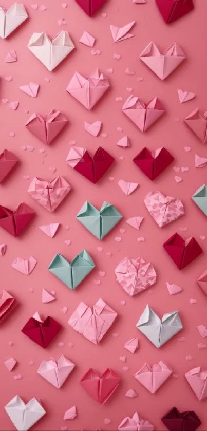 Pink wallpaper with origami hearts in various shades.