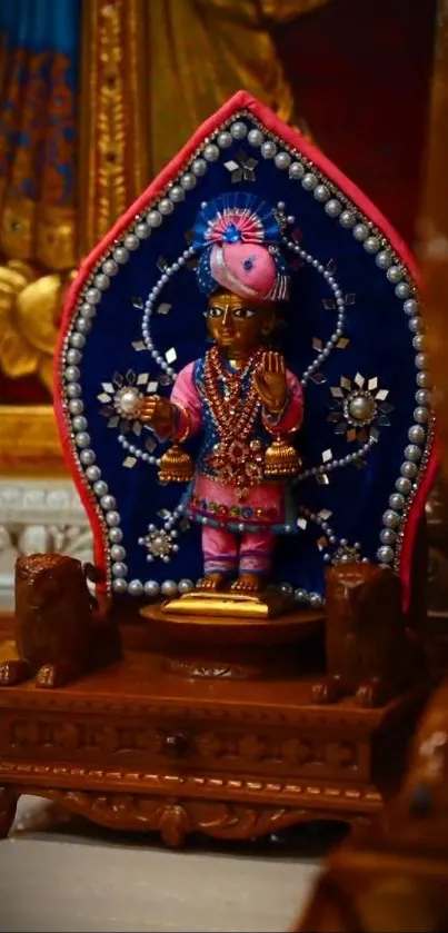 Intricately adorned deity statue on display in a temple setting.