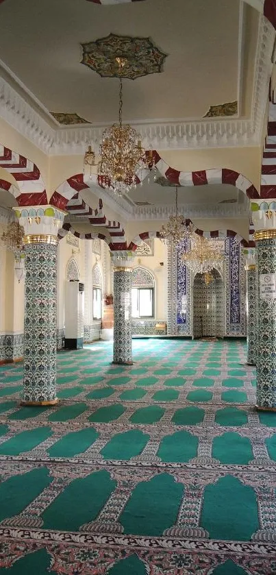 Intricate mosque interior with ornate, colorful pillars and teal carpeting.