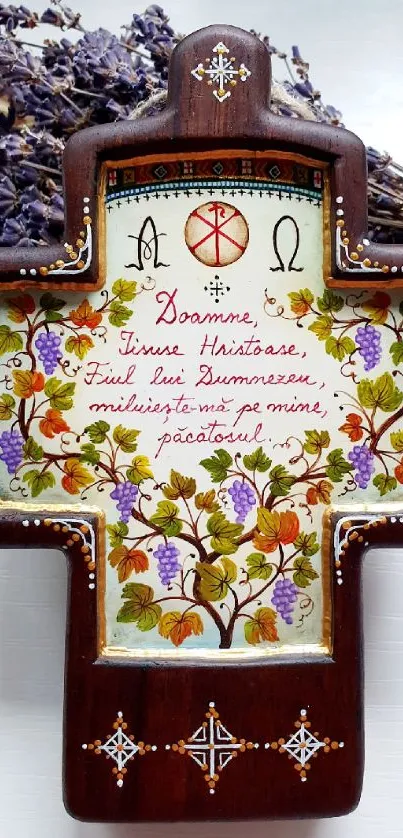 Intricate wooden cross with floral patterns and lavender accents.