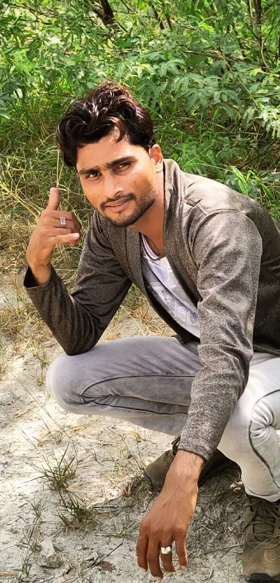 Casual man posing with green backdrop.