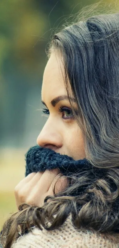 Cozy autumn portrait of woman with curly hair outdoors.