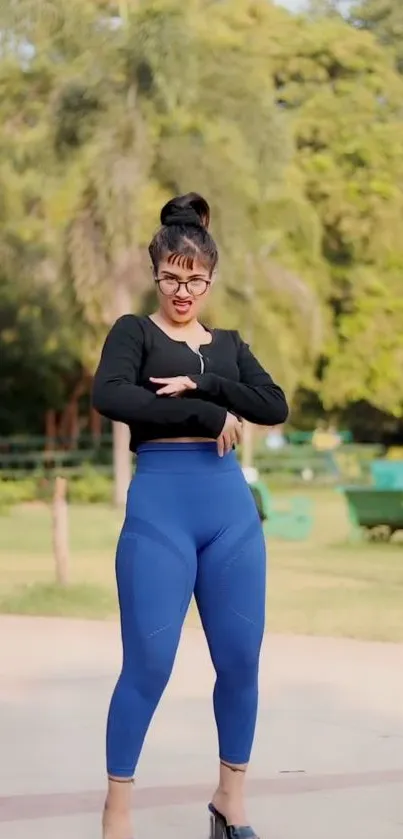 Woman wearing activewear in a green park setting.