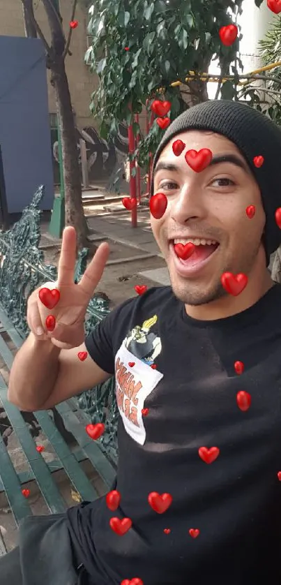 Smiling person with a peace sign outdoors on a sunny day.