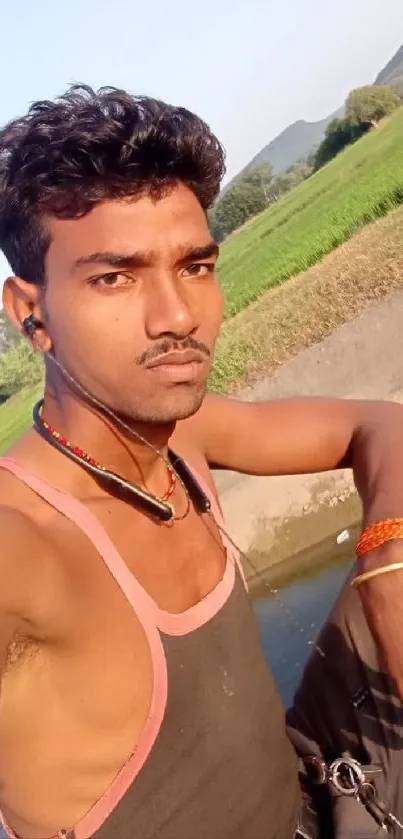 Young man outdoors with greenery background