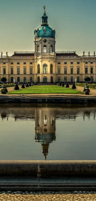 Palace reflected in tranquil pond with lush gardens and clear sky.