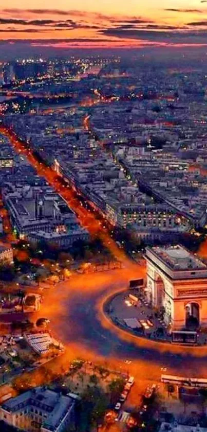 Aerial view of Paris at dusk with Arc de Triomphe and city lights.