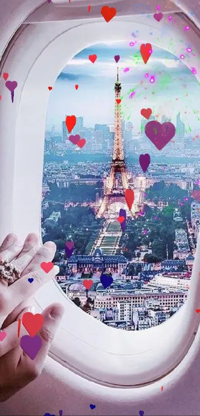 View of Paris and Eiffel Tower through airplane window; hands on window sill.