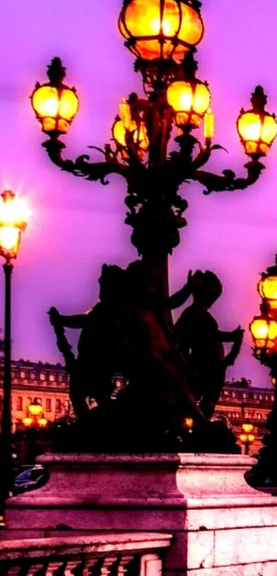 Illuminated Parisian street lamps against a purple evening sky.