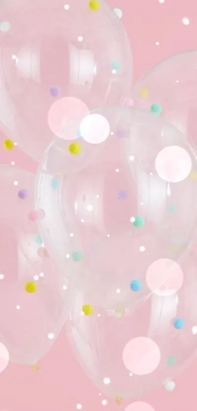 Clear balloons with colorful dots on pink wallpaper.