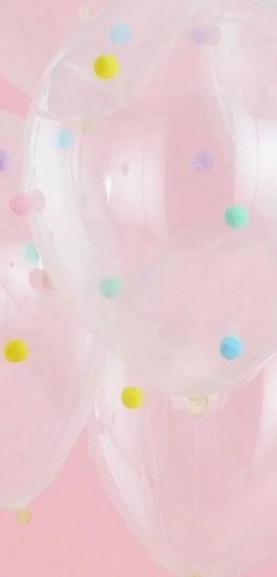 Transparent balloons with colorful dots on a pastel pink background.