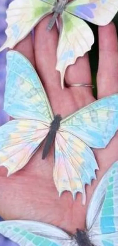 Pastel butterflies rest gracefully on an outstretched hand.