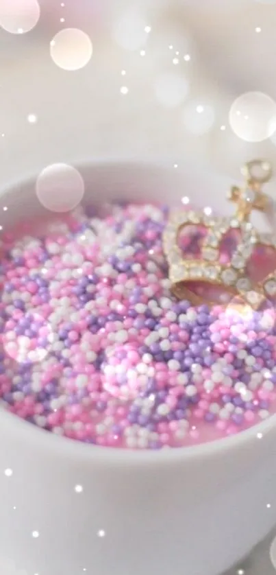 Pink and purple candy sprinkles with a gold crown in a white bowl.