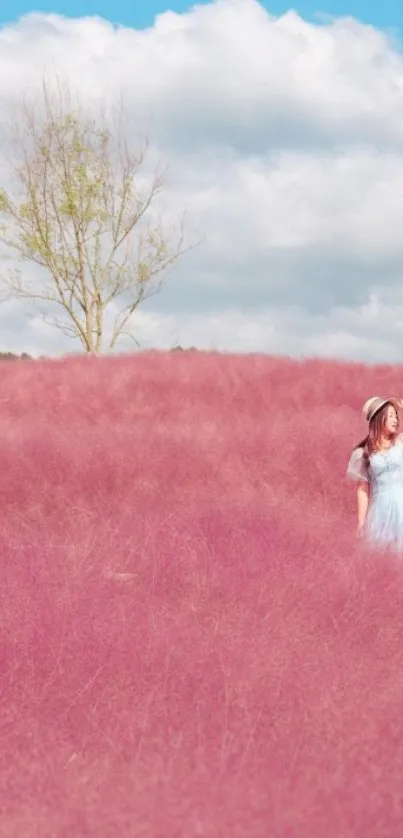 Woman in pastel pink field under blue sky.