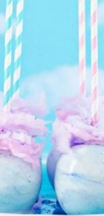 Pastel drinks with cotton candy and straws against a cloudy sky.