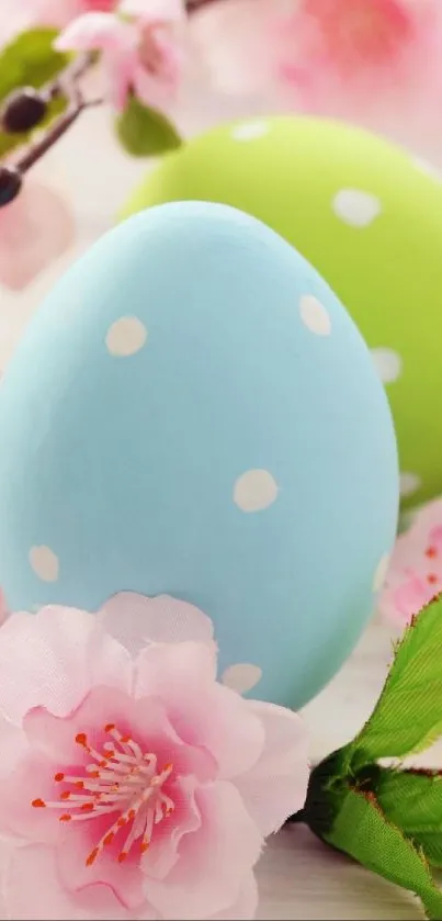 Pastel blue and green Easter eggs with pink blossoms.