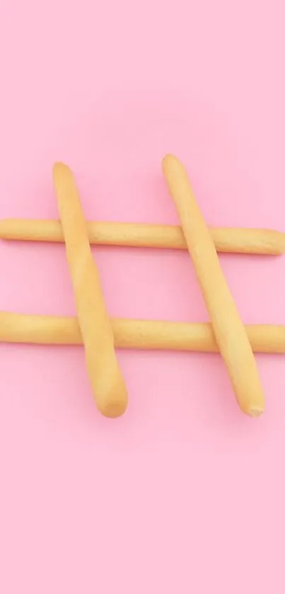 Pink wallpaper with wooden sticks forming a hashtag shape.