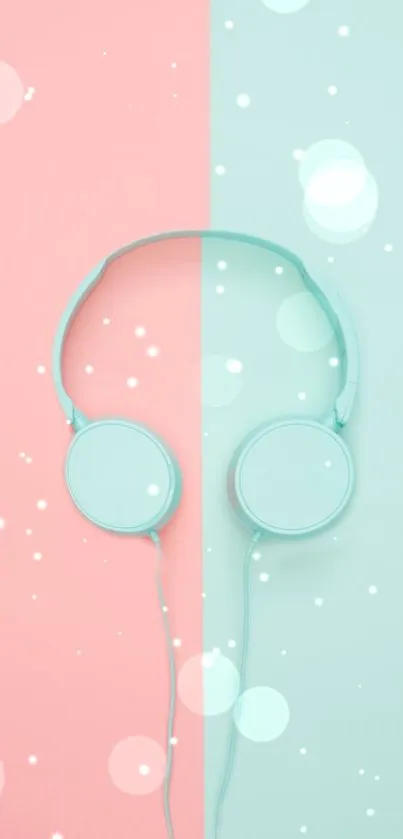 Mint and pink headphones on a split pastel background wallpaper.