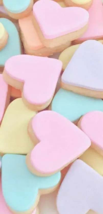 Pastel heart-shaped cookies in pink, blue, and yellow hues.