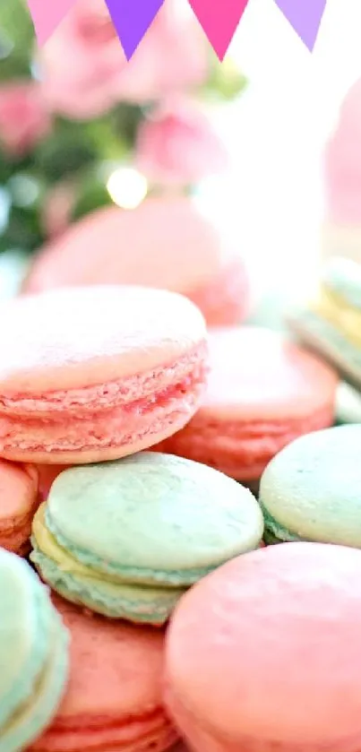 A plate of pastel pink and blue macarons on a decorative dish.