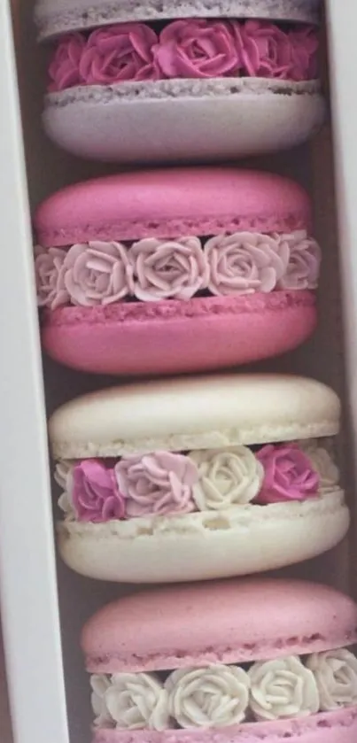 Pastel macarons decorated with roses in a box.