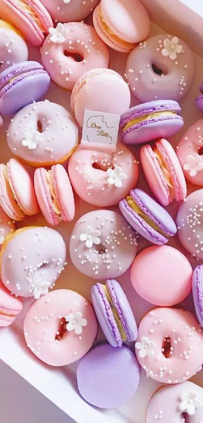 Pastel macarons and donuts in assorted colors create a sweet-themed wallpaper.