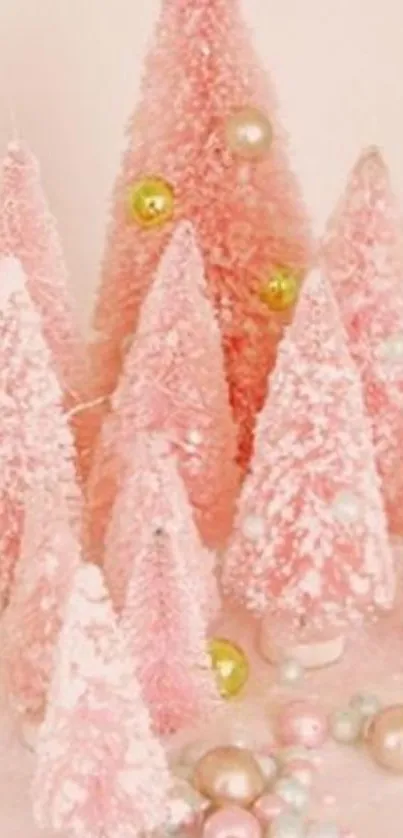 Pastel pink Christmas trees with baubles.