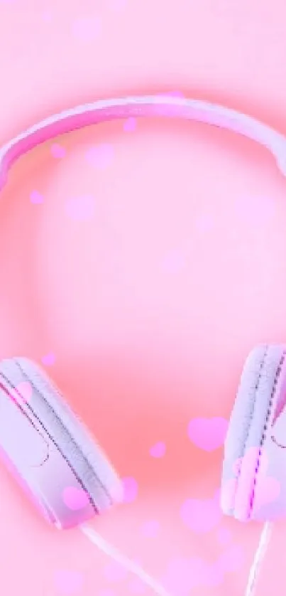 Pastel pink headphones on a pink background.