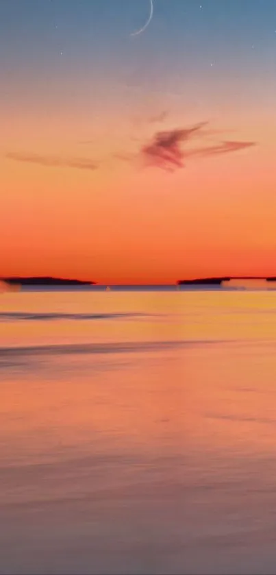 A calm ocean under a pastel pink and orange sunset sky.