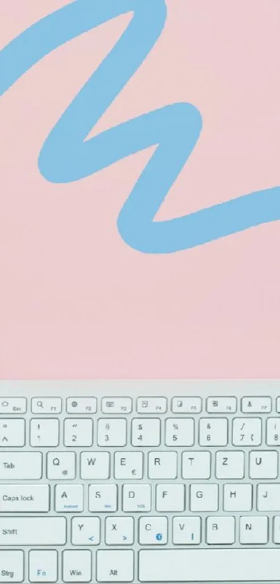 Pastel pink workspace with a keyboard, headphones, and a notebook.