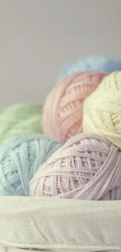 Basket of pastel yarn balls in soft hues.