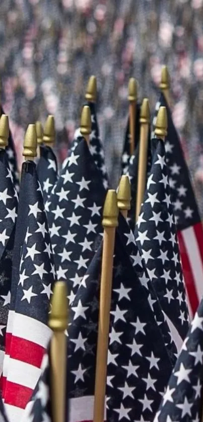 A display of multiple American flags with stars and stripes on a mobile wallpaper.