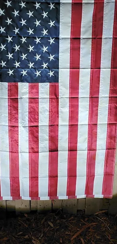 American flag with stars and stripes on wooden backdrop.