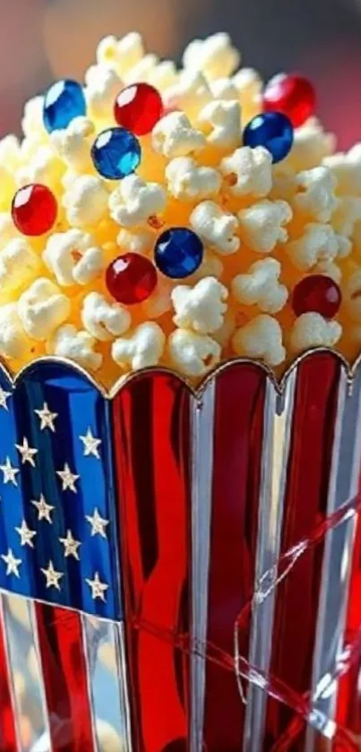 Patriotic popcorn with colorful candy in red and blue stripes container.