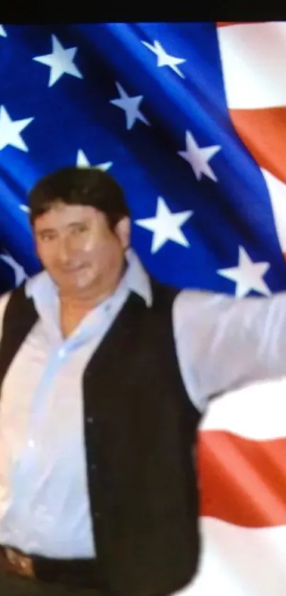 Man posing joyfully in front of an American flag.