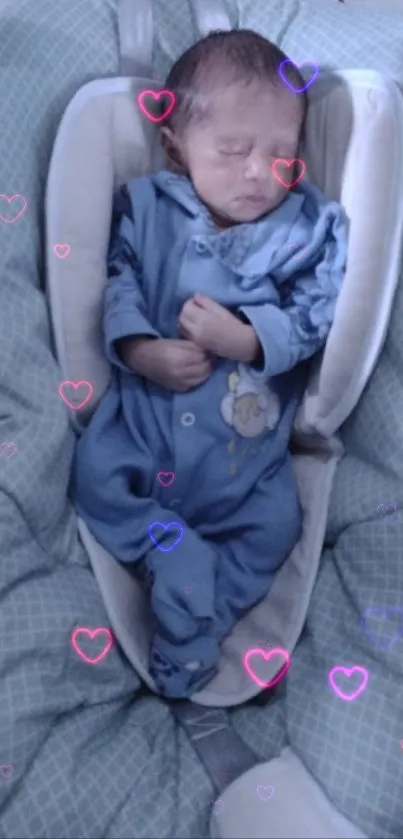 Sleeping baby in blue outfit on cozy bedding.