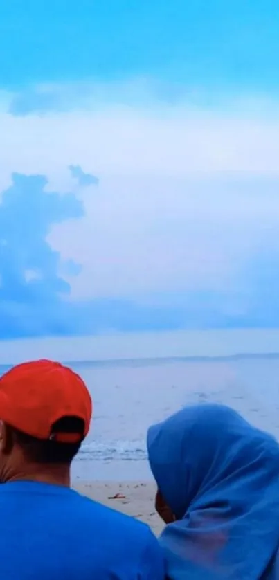 Couple enjoying a serene beach under a vibrant sky.