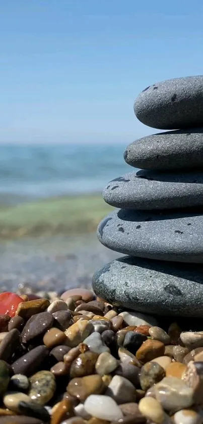 Smooth stones stacked on a tranquil beach.