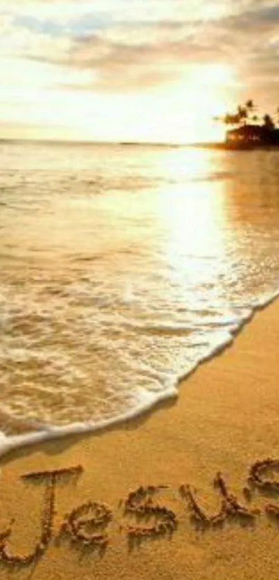 Beach sunset with 'Jesus' written in sand, perfect tranquil wallpaper.