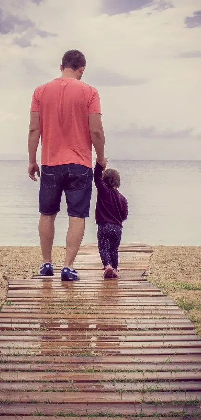 Father and child walking on a beach boardwalk.