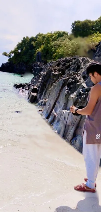 A person standing on a serene beach with rocky cliffs and calm waters.